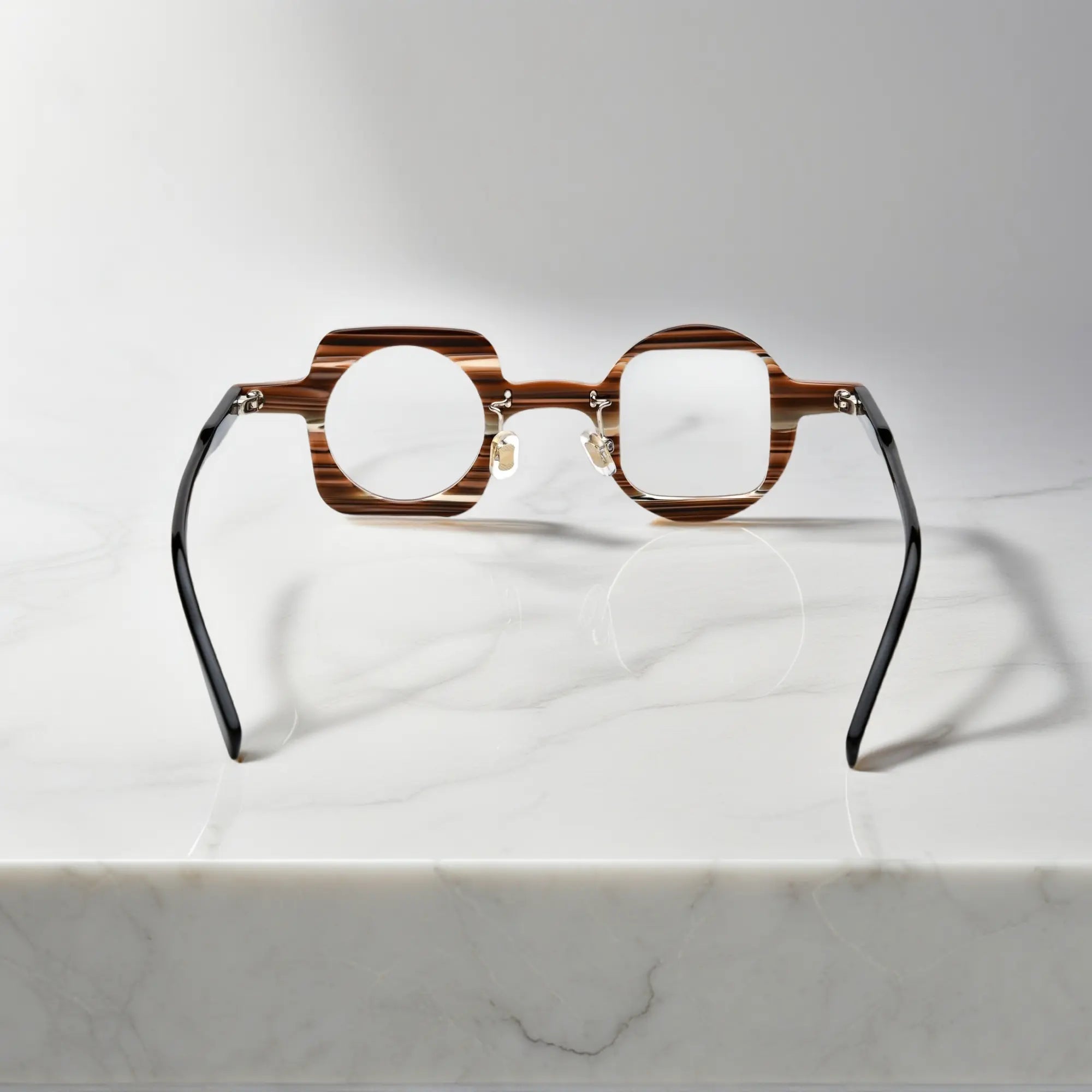back view of VoyueLens asymmetrical brown stripe glasses showing nano-polished acetate frame, ergonomic silicone nose pads, and standard metal hinge.